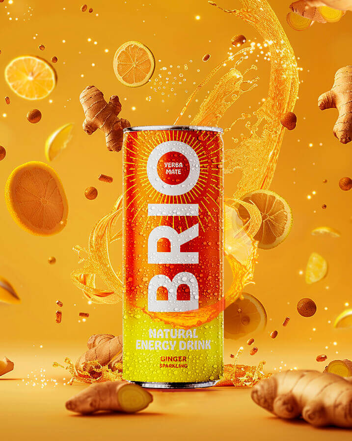 Product shot of a Brio Ginger Energy Drink, mate can with yerba mate with a splash of liquid and falling ginger pieces and orange slices.
